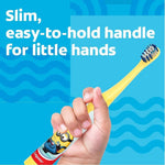 Child's hand holding a slim yellow Colgate Minions toothbrush with an easy-to-hold handle.