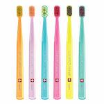 Six colorful Curaprox Ultra Soft smart toothbrushes in orange, pink, blue, and yellow.