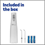 Waterpik water flosser kit with replacement tips and AA batteries included in the box.