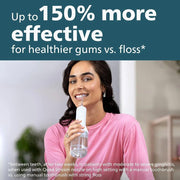 Woman using a water flosser for effective gum health and oral hygiene compared to string floss.