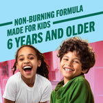 Smiling children enjoying a non-burning oral care formula made for kids 6 years and older.