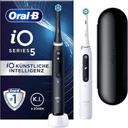 Oral-B iO Series 5 electric toothbrush in black and white with a travel case.