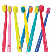 Assorted colorful Curaprox ultra soft toothbrushes for oral hygiene.