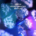Close-up of gentle micro-vibrating toothbrush bristles with blue and purple light effects.